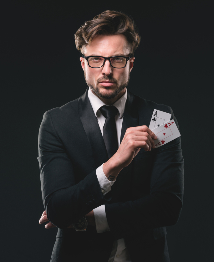 Male gambler holding pair of aces